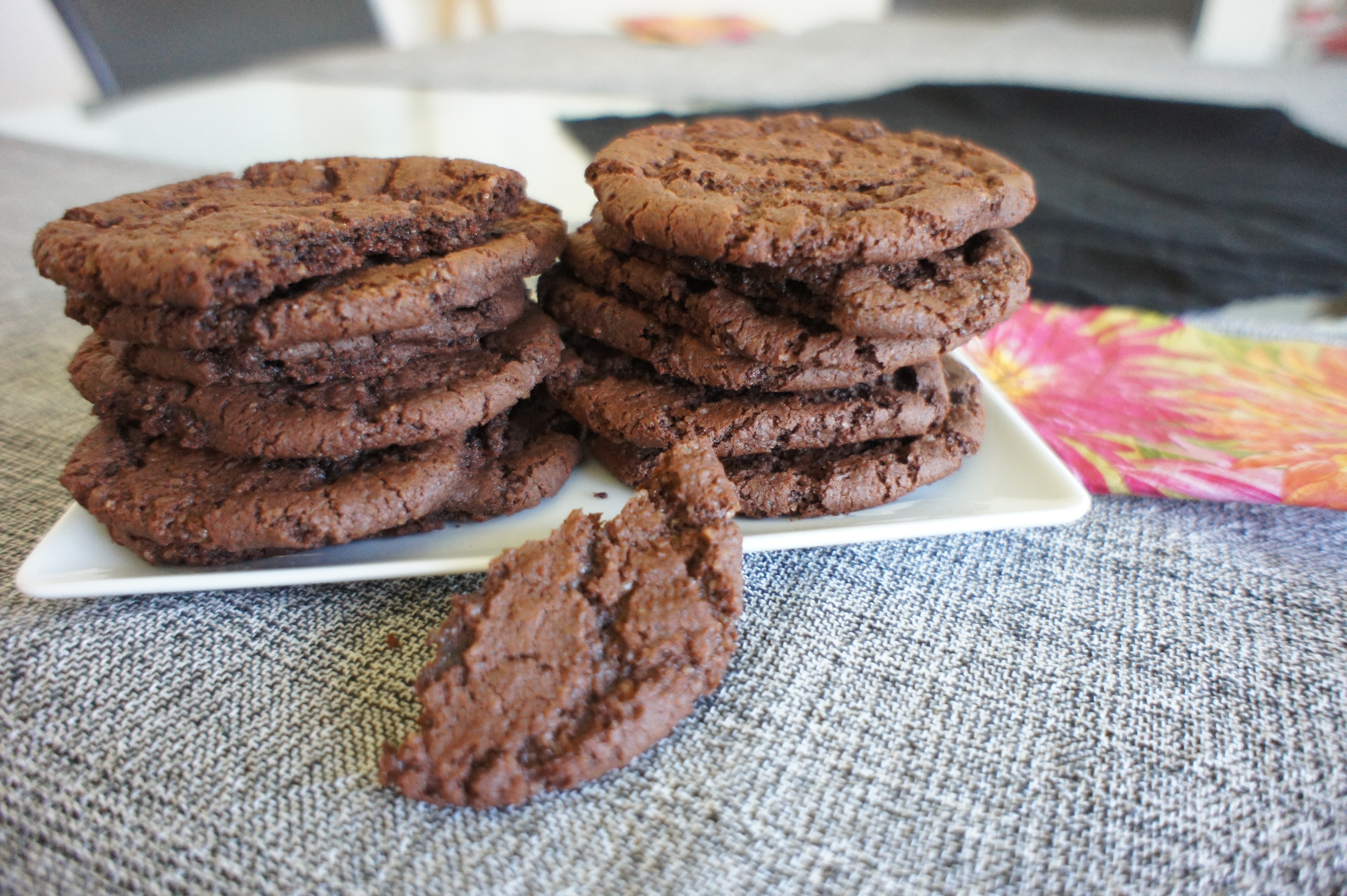 Chocolate sugar cookies with half a cookie