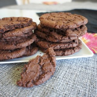 Chocolate sugar cookies with half a cookie